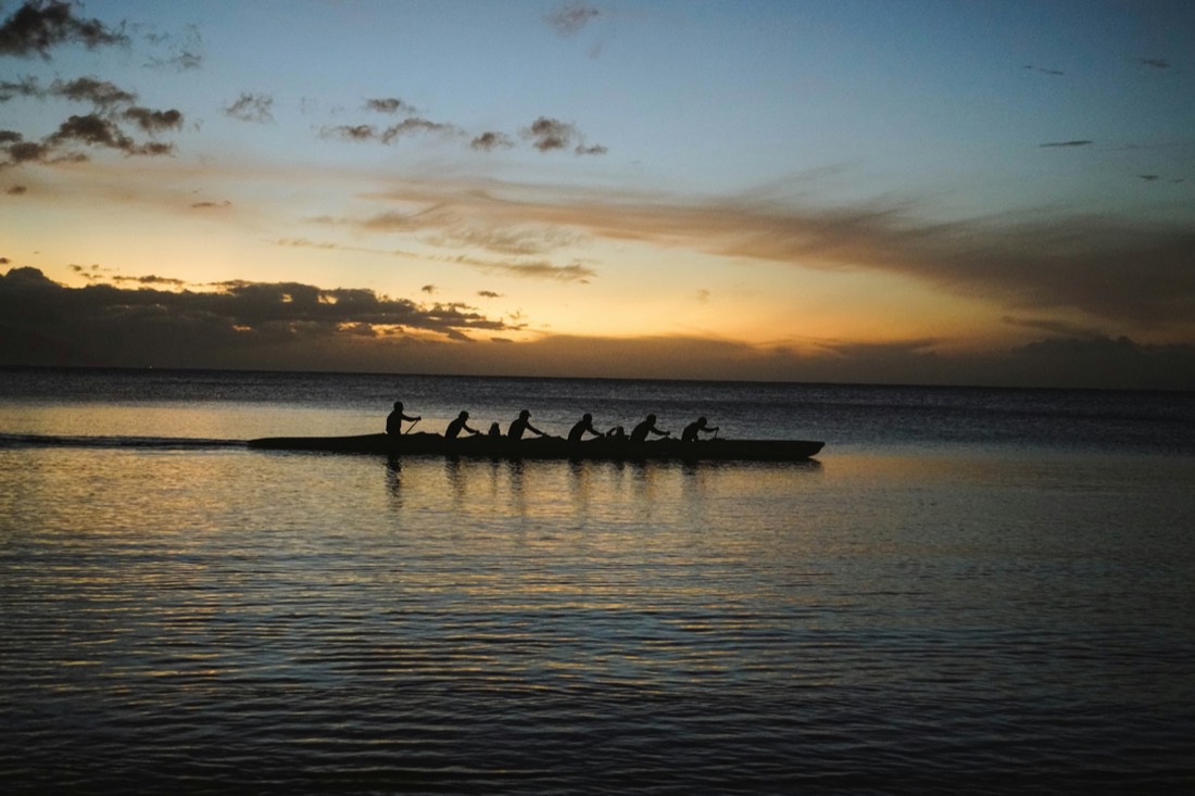 Rowing crew in sync at golden hour